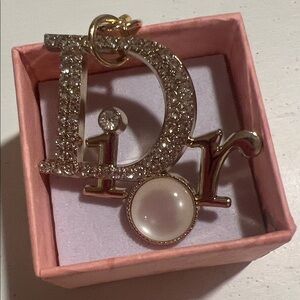 Dior- Gold Tone 'Dior' Crystal Logo with Pearl Accent Charm